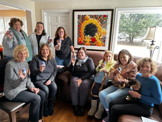 Residents and staff enjoying an activity together in a cozy living room