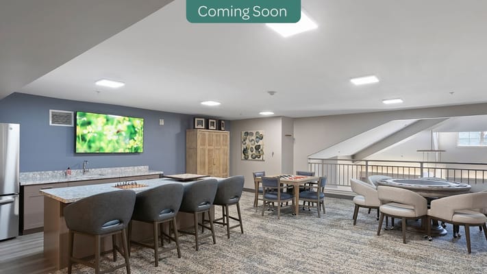 Interior view of the common area with seating and a television.