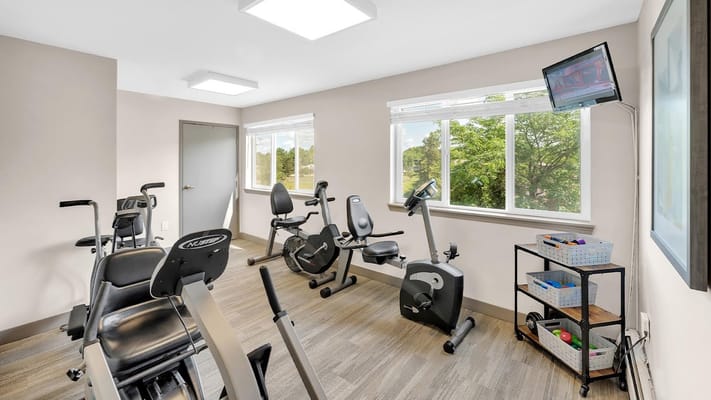 Fitness room with exercise bikes and weights