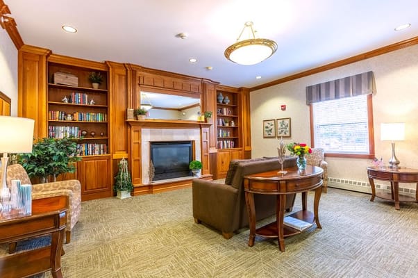Inviting living room with bookshelves and comfortable seating.