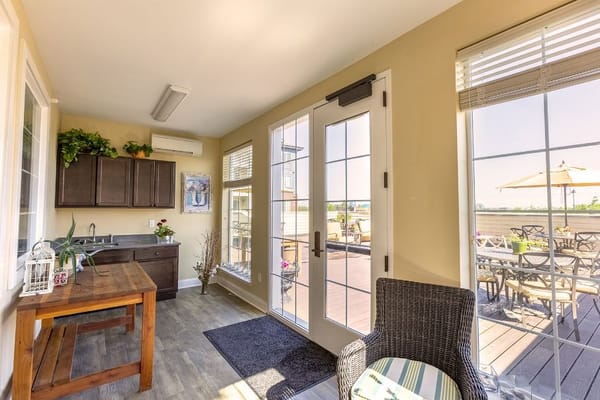 Bright sunroom with seating and access to outdoor patio