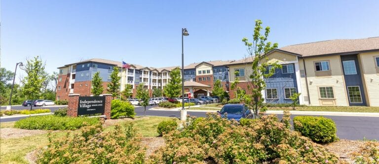 Exterior view of Independence Village of Fishers East showing landscaped entrance and building.