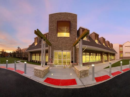 Exterior view of a senior living facility at sunset