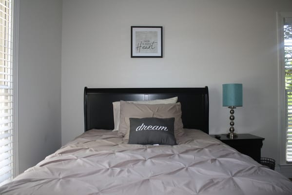 Cozy private resident room with a bed and decorative pillow