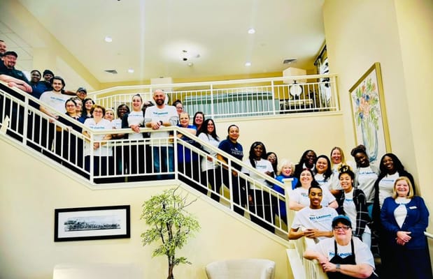 Staff and residents gathered in a bright community space