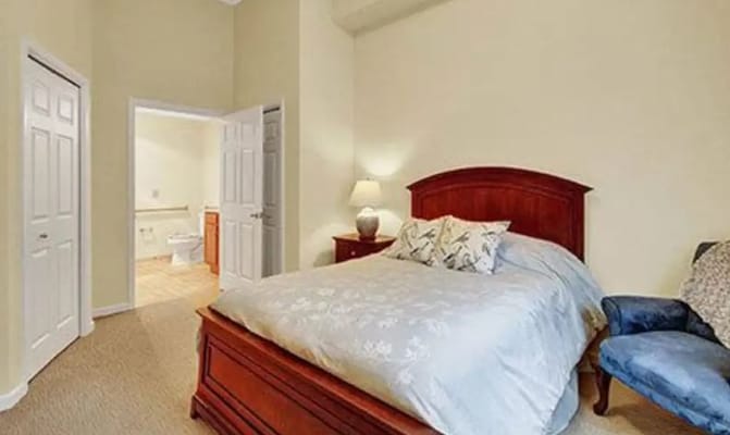 Cozy resident bedroom with a bed and ensuite bathroom