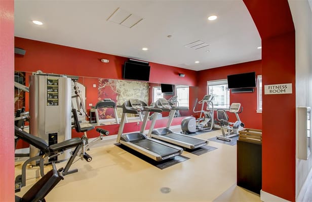 Well-equipped fitness room with exercise machines