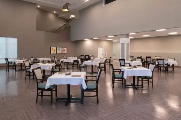 Spacious dining room with tables set for meals