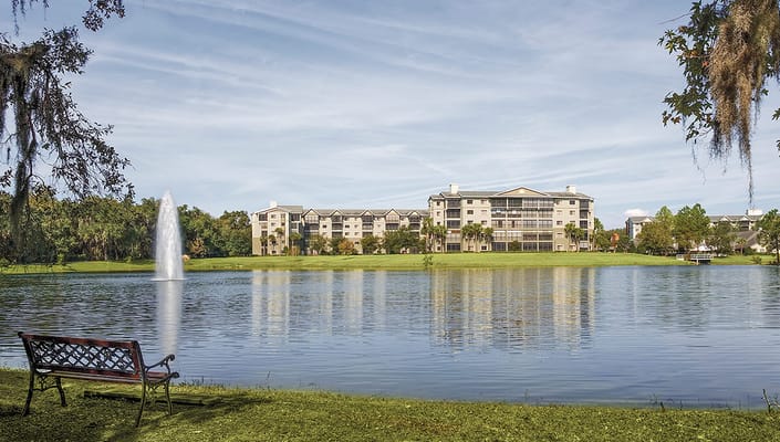 Exterior view of the Lake Port Square facility by a serene lake