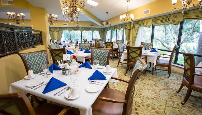Dining room set up for a meal with blue napkins