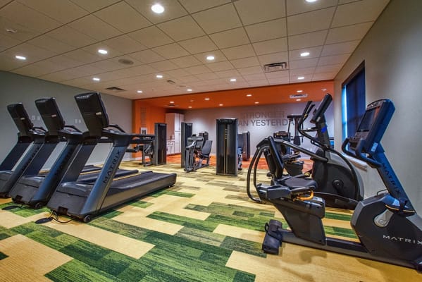 Fitness center with exercise equipment in a bright interior