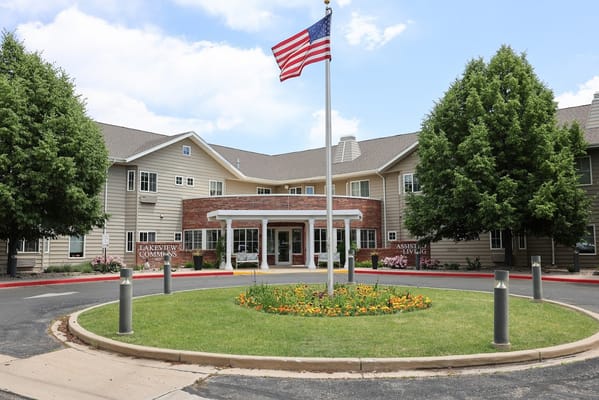 Front view of Lakeview Commons with a flag and flowers