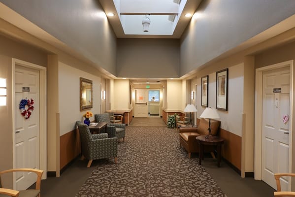 Interior hallway of a senior living facility with seating areas