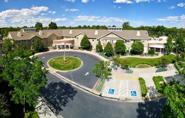 Aerial view of Lakeview Commons senior living facility with landscaped entrance.