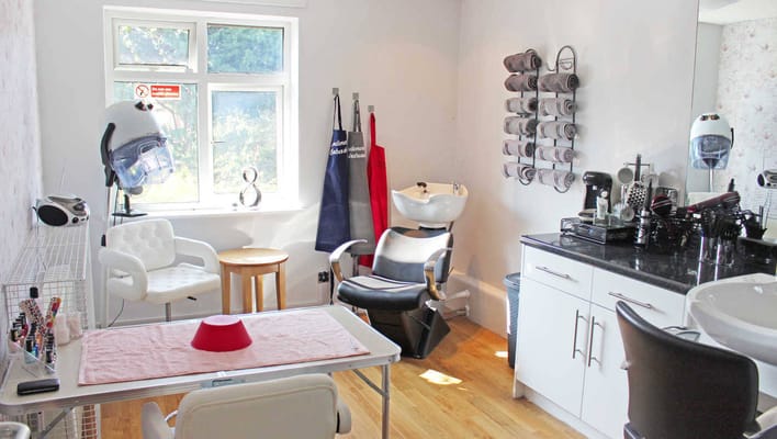 Interior of hair salon with styling chairs and equipment
