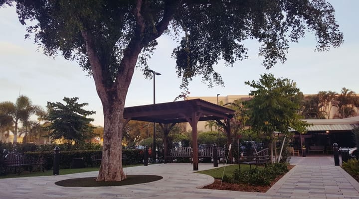 Outdoor area with a shaded pavilion and landscaped garden