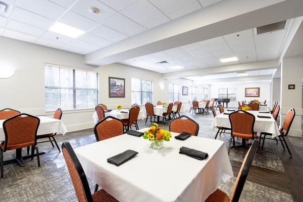 Bright dining room with tables set for meals