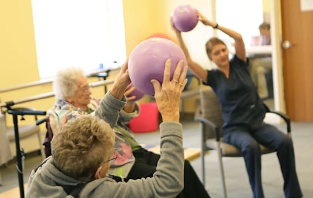 Residents participating in an exercise class using balls