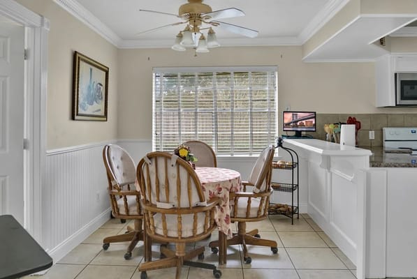 Bright dining area with a round table and chairs