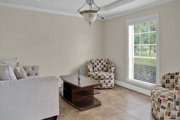 Bright common area with seating and a view outside