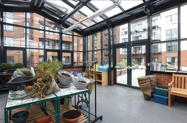 Indoor greenhouse with plants and seating area