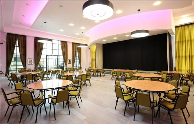 Bright and spacious activity room with tables and chairs