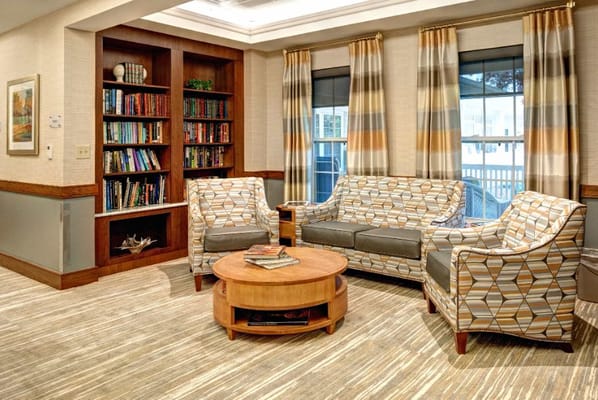 Cozy common area with seating and bookshelves