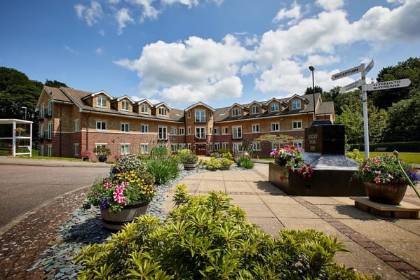 Exterior view of Loxley Park with flowers and signage