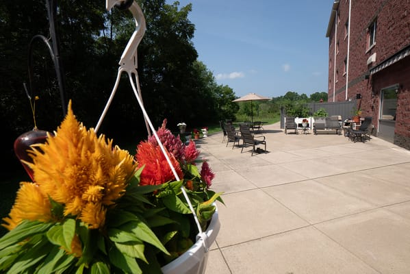 Outdoor seating area with colorful flowers and patio furniture