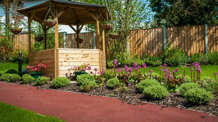 Well-maintained garden with flowers and a gazebo