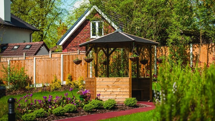 Garden gazebo surrounded by colorful flowers