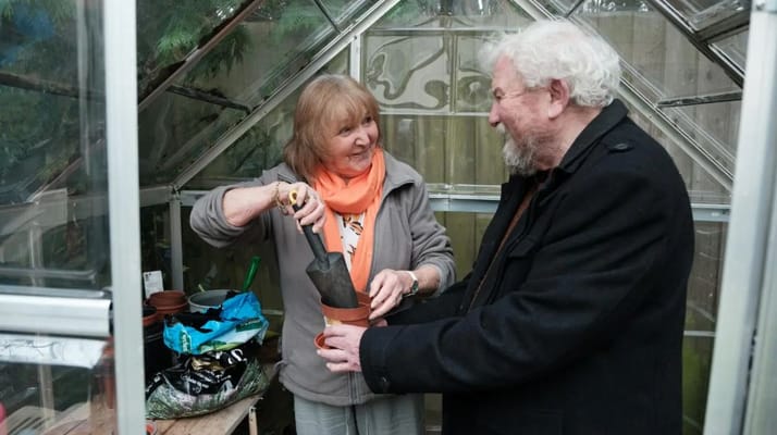 Residents enjoying an activity in a greenhouse
