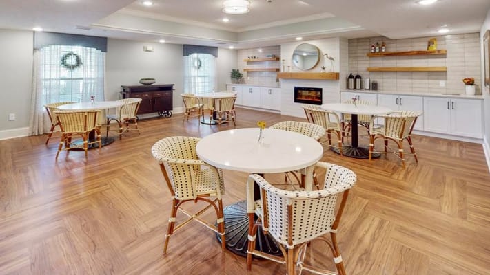 Bright common area with seating and wooden floors