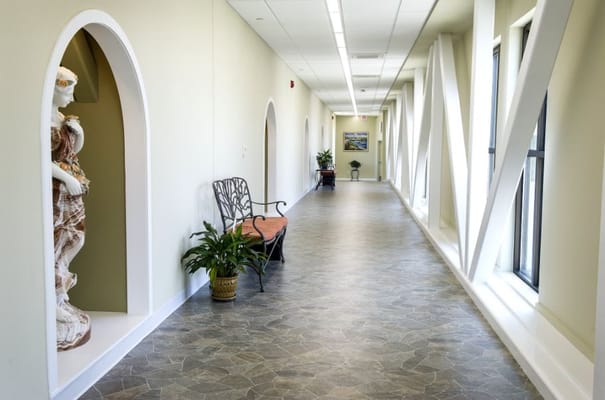 Bright interior hallway with seating and art