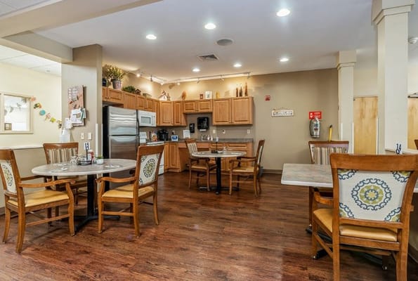 Dining tables and kitchen area in Maidencreek Place
