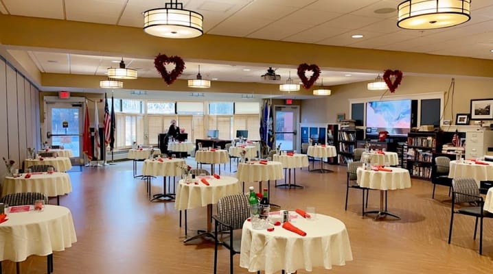 Dining room setup for a special event with tables and decorations