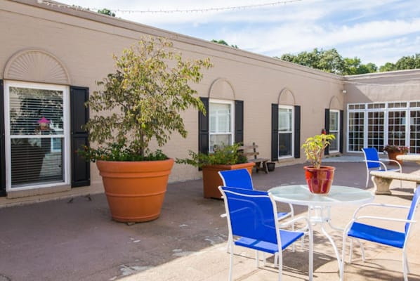 Outdoor seating area with flowers and tables