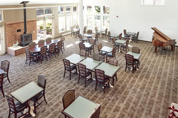 Bright and spacious common area with tables and chairs