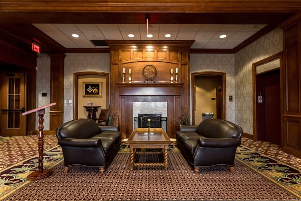 Interior seating area with leather sofas and a fireplace
