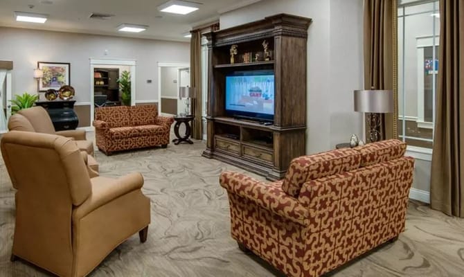 Spacious common area with comfortable seating and a television