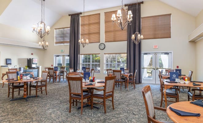 Dining area with tables and chairs, bright lighting