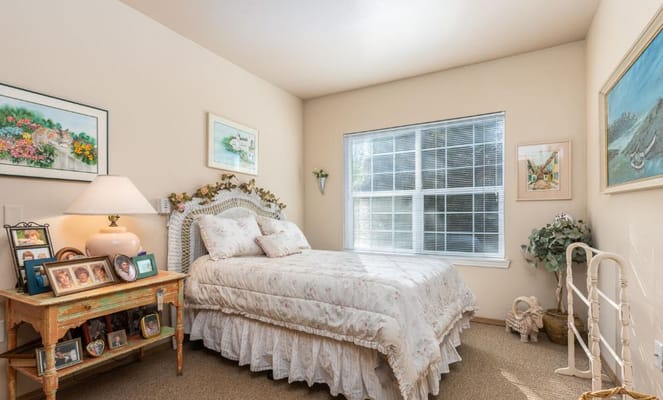 Cozy resident room with a floral bedspread and artwork