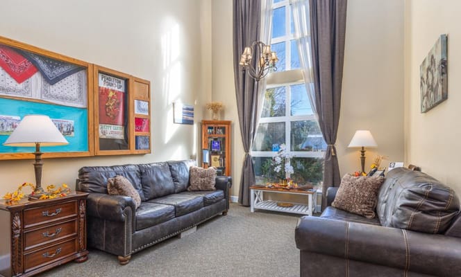 Cozy common area with two leather sofas and art on the walls