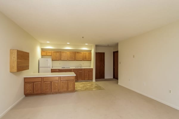 Interior view of a kitchen with wooden cabinets and appliances