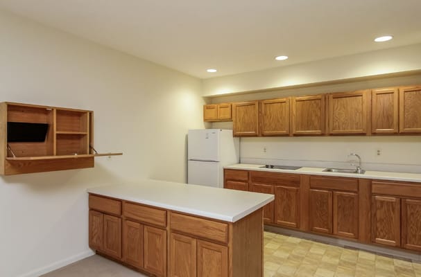 Spacious kitchen with wooden cabinets and countertop