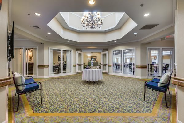 Bright entrance lobby with decorative chandelier and seating