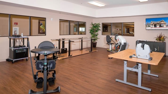 A therapy room featuring various rehabilitation equipment