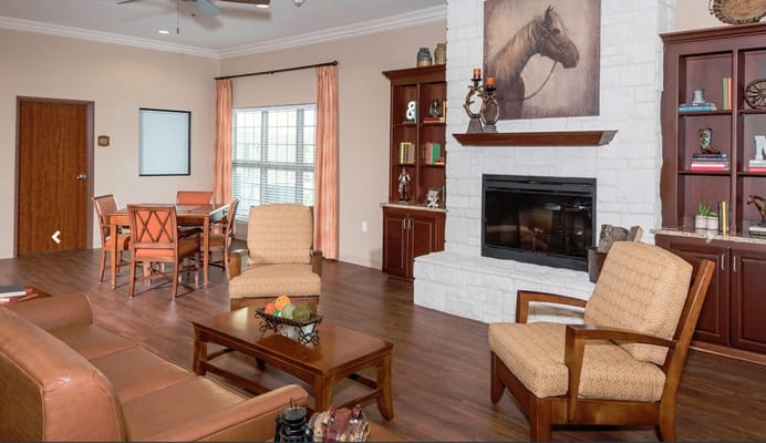 A cozy living room with comfortable seating and a fireplace.