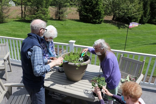 Residents gardening on an outdoor patio