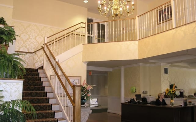 Bright lobby area with reception desk and stairs